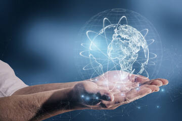 Poster - Close up of male hand holding abstract glowing globe hologram on blurry blue background. Digital network, data and science concept.