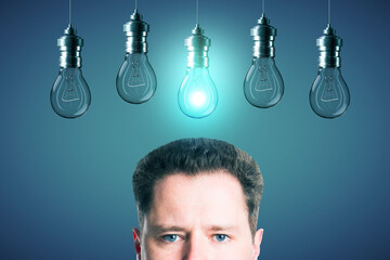 Poster - Half portrait of young european businessman with abstract glowing row of light bulbs on red background. Idea, solution and innovation concept.