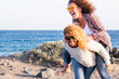 © simona - Beautiful crazy caucasian people young women carry on eachother having a lot of laughs and fun for friendship - outdoor leisure activity and vacation concept for females friends smiles and gone crazy
