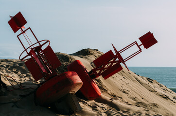 Closeup shot of red special metal equipment on a sandy hill