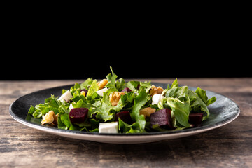 Wall Mural - Beetroot salad with feta cheese,lettuce and walnuts on rustic wooden table	