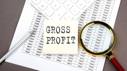 Poster - GROSS PROFIT text on sticker on the chart ,with calculator and magnifier