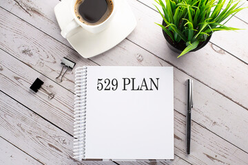 Poster - Cofee cup, notepad,pen on wooden background. Business concept. Text 529 PLAN