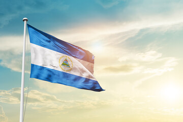 Nicaragua national flag cloth fabric waving on the sky - Image