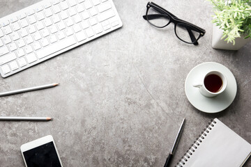 White desk office with laptop, smartphone and other work supplies with cup of coffee. Top view with copy space for input the text. Designer workspace on desk table essential elements on flat lay