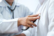 © Freedomz - Cropped image of male doctor's hand using stethoscope to examining heartbeat and symptom of patient while talking