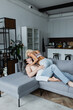 © LIGHTFIELD STUDIOS - sexy young woman seducing shirtless man in couch