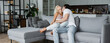 © LIGHTFIELD STUDIOS - young man kissing neck of blonde girlfriend with closed eyes in living room, banner