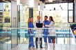 © Monkey Business - Multi-Cultural Medical Team Wearing White Coats And Scrubs Discuss Patient Scan Meeting In Hospital