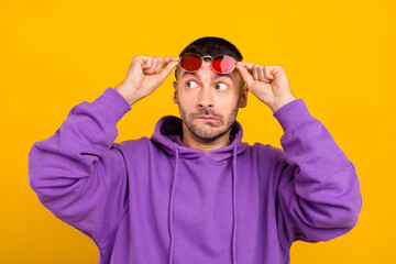 Wall Mural - Photo portrait young man wearing sunglass looking copyspace afraid isolated vibrant yellow color background