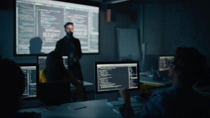 Fototapete - Teacher Giving Computer Science Lecture to Diverse Multiethnic Group of Female and Male Classmates in Dark College Room. Student Raises Hand and Answers Lecturer a Question About Software Engineering.