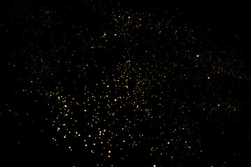 Wall Mural - golden blurred bokeh lights on black background. glitter sparkle stars for celebrate. overlay for yo