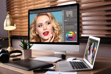 Fototapete - Retoucher's workplace. Computer with photo editor application, camera, laptop and graphic tablet on table indoors