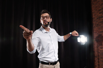 Wall Mural - Motivational speaker with headset performing on stage