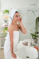 Canvas Print - Beautiful young woman in bathroom. Facial wash