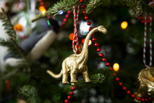 Close Up Brass Brontosaurus Dinosaur Ornament On Christmas Tree