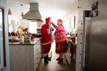 Couple Dressed In Christmas Costumes