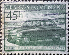 Czechoslovakia Circa 1955: A postage stamp printed in Czechoslovakia showing an antique motor vehicle with a woman at the wheel. Škoda Sedan