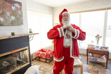 Man Getting Dressed In Santa Claus Costume