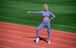 © be free - athletic woman in fitness wear training on stadium, fitness