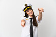 Brazilian girl Airplane pilot over isolated white background points finger at you while smiling