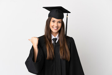 Wall Mural - Teenager Brazilian university graduate over isolated white background pointing to the side to present a product