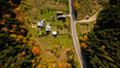 Aerial view of secluded cottage in the woods. Log cabin in the forest in rural. View from above.