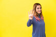 © luismolinero - Young woman over isolated yellow background happy and counting four with fingers