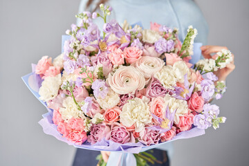 Beautiful bouquet of flowers in woman hand. Floral shop concept . Beautiful fresh cut bouquet. Flowers delivery