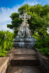 Sticker - Big gravestone in the shape of a cross with sculptures of two girls in the cemetery