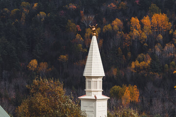 Wall Mural - View of the white chapel, steeple in Dog Mountain, St. Johnsbury, VT, foliage, during autumn