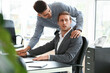 © Pixel-Shot - Man harassing his male colleague in office