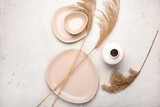 Fototapeta Boho - Dry common reeds and dishes on white background