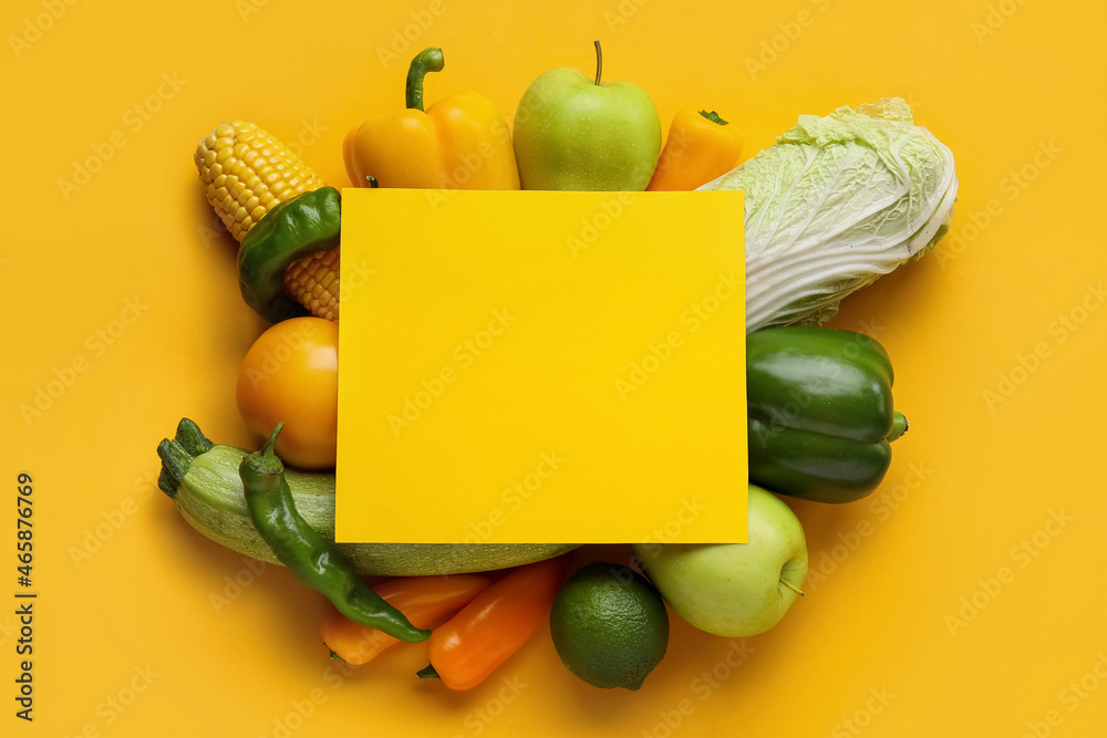 Composition with vegetables, fruits and blank card on color background. Vegan Day
