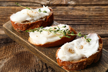 Wall Mural - Pieces of bread with lard spread on wooden background