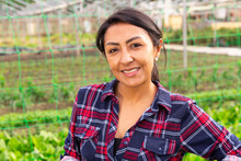 Happy Middle Aged Latin American Woman Farmer Smiling At Vegetable Plant Factory