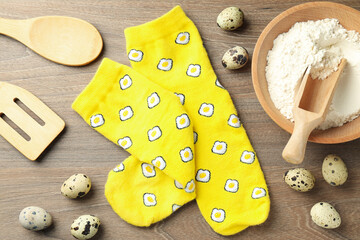 Wall Mural - Cooking concept with socks with eggs on wooden background