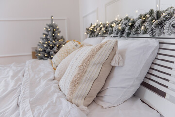 Wall Mural - New Years interior. On the festive bed there is white bed linen with ornamented pillows mustard rug