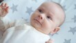 © Valua Vitaly - Sweet newborn boy lies on the sofa. Beautiful infant boy with blue eyes.  Cute two-month-old baby in white clothes. High angle view of a chubby male kid.  Closeup portrait of calm baby.
