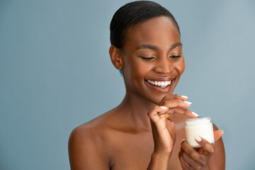 Wall Mural - Black mid adult woman applying cream on face