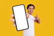 Man pointing at white empty smartphone screen, mockup