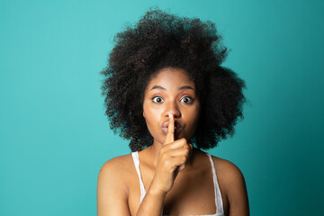 Wall Mural - cute woman with afro hairstyle with silence gesture 