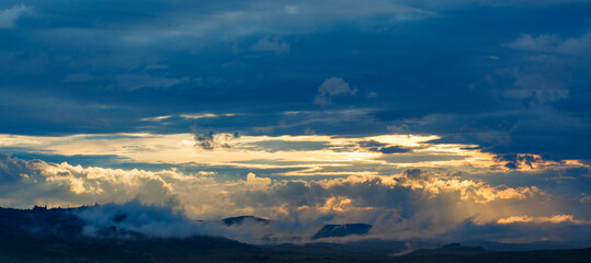 Wall Mural - Sunset over the mountains in a panoramic landscape