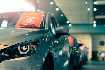 Sticker - Selective focus grey car parked in luxury showroom. Car dealership office. New car parked in modern showroom. Car for sale and rent business concept. Automobile leasing and insurance background.