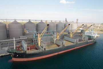 loading grain into holds of sea cargo vessel through an automatic line in seaport from silos of grai