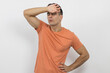 ©  Yistocking - a young man touching his forehead because he is sick on a white background.