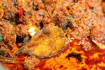 Wall Mural - Closeup of Stir Fried Crispy Catfish with Curry background thai street food market