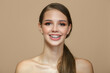 © Alena - young woman smiling with braces set. Beige background