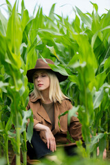 Canvas Print - Blonde woman in cloak and hat in cornfield in summertime