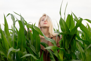 Canvas Print - Blonde woman in cloak in cornfield in summertime